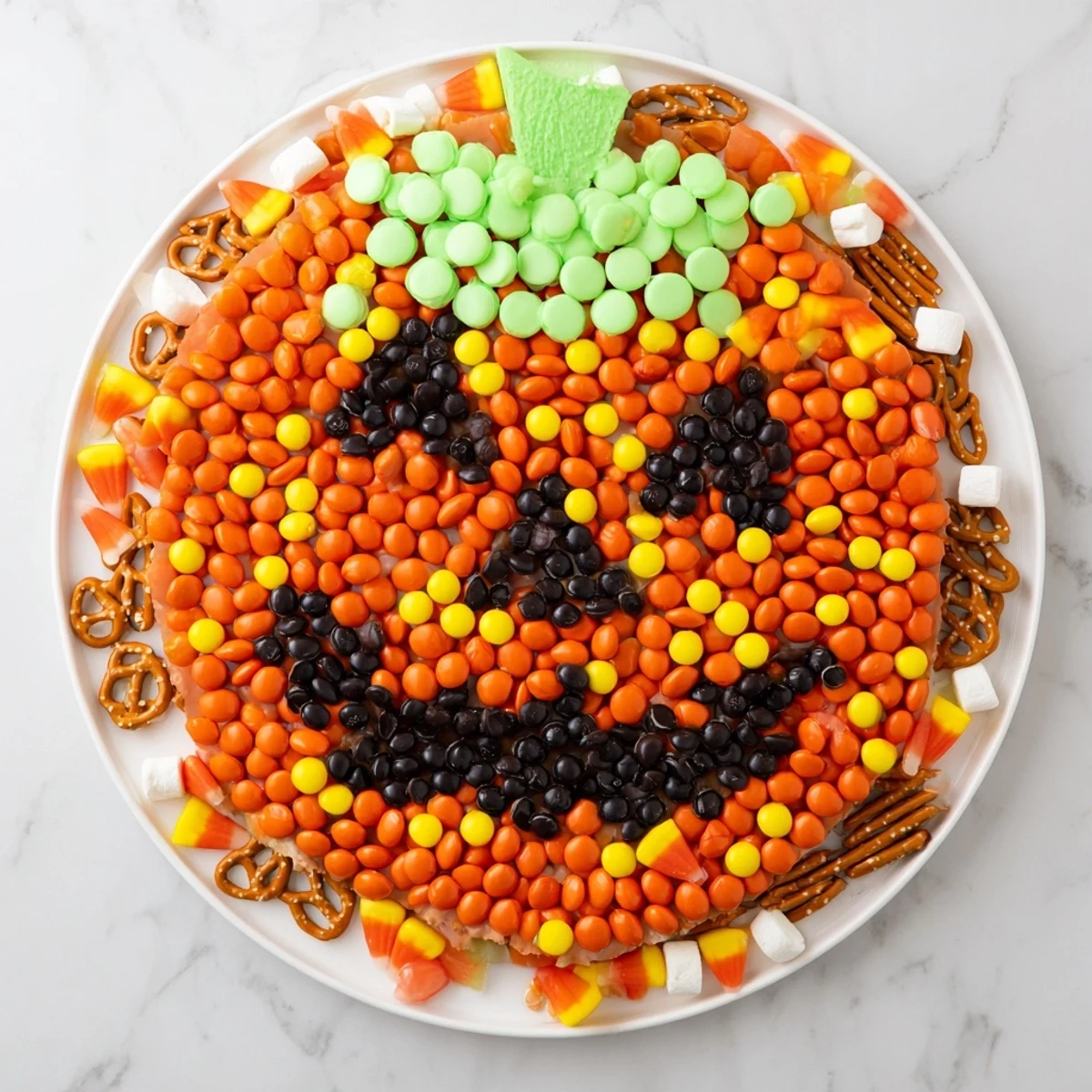 A close-up view of the Jack-o-Lantern Candy Board reveals layers of sweet treats perfect for sharing and celebration.