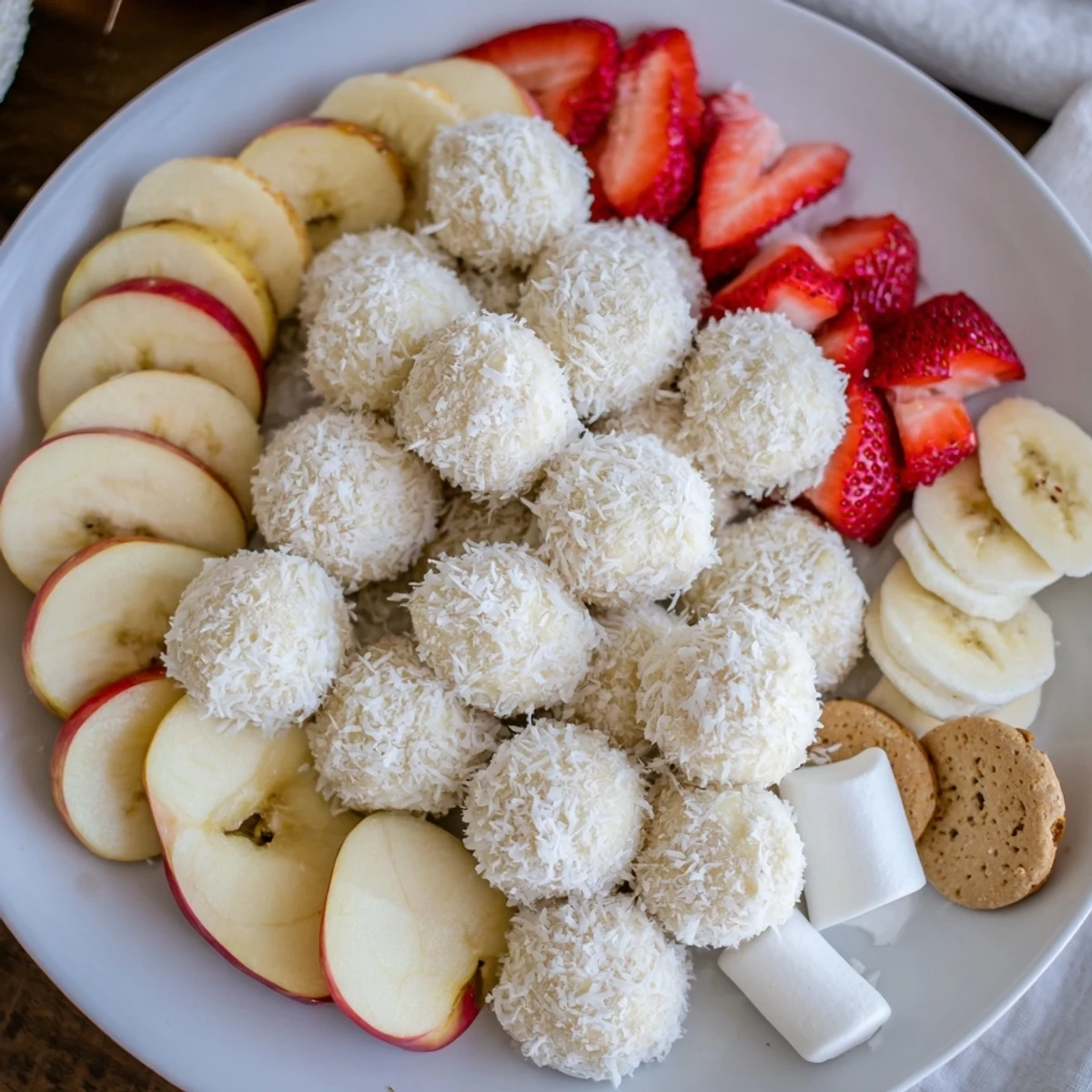 Bright and festive, this Marshmallow Snowball Dip Platter features snowy coconut balls for fun.