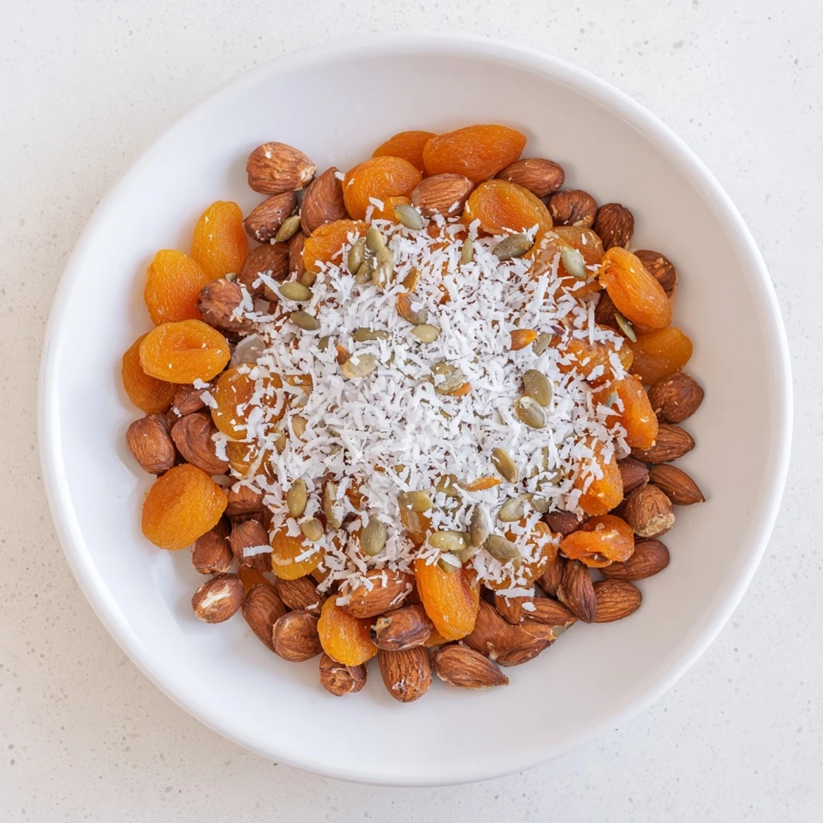 Pile of almonds and dried apricots offers a sweet and savory snack, ready in minutes.