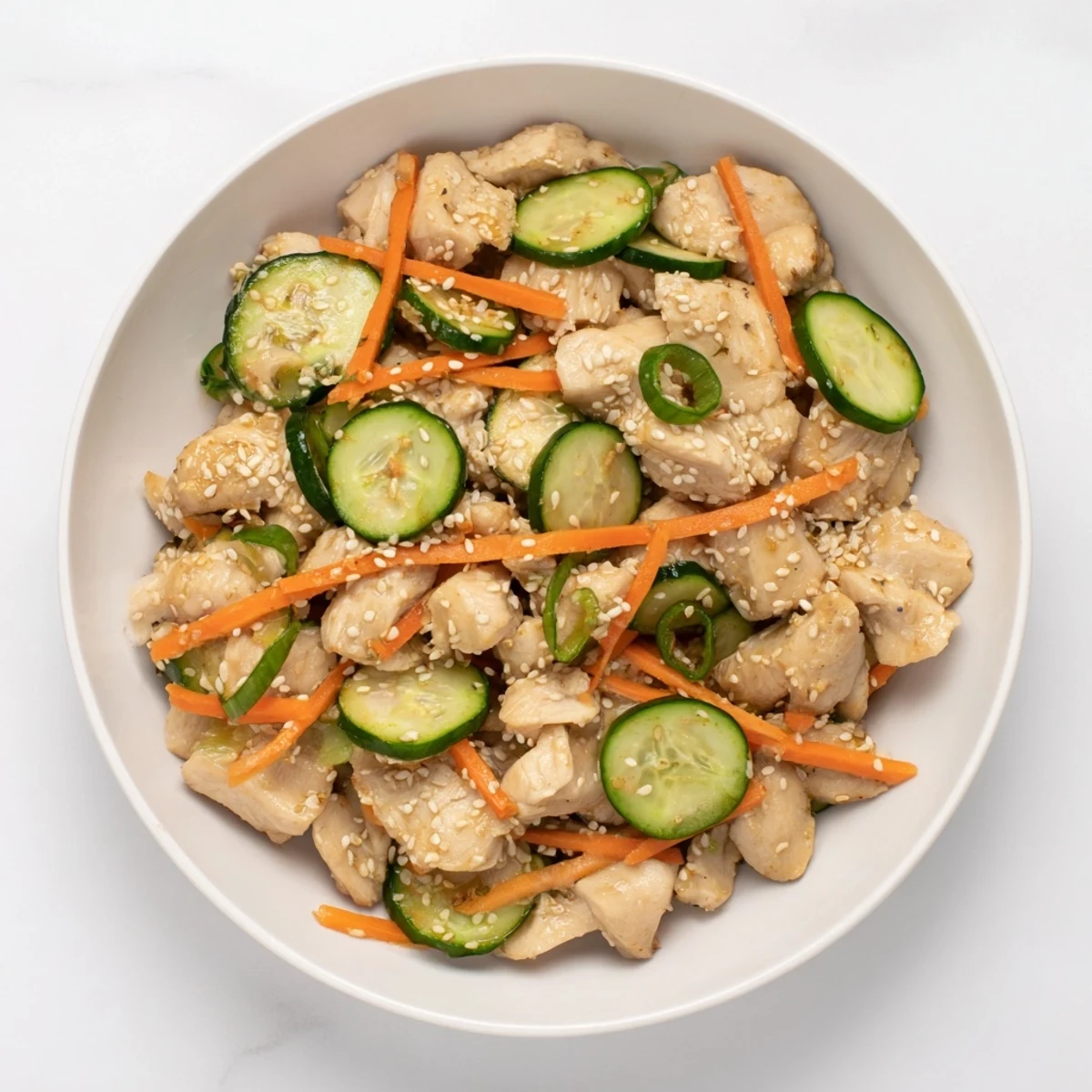 Deli Container Shaker Chicken Salad showcases vibrant cucumbers and chicken in a savory soy dressing.
