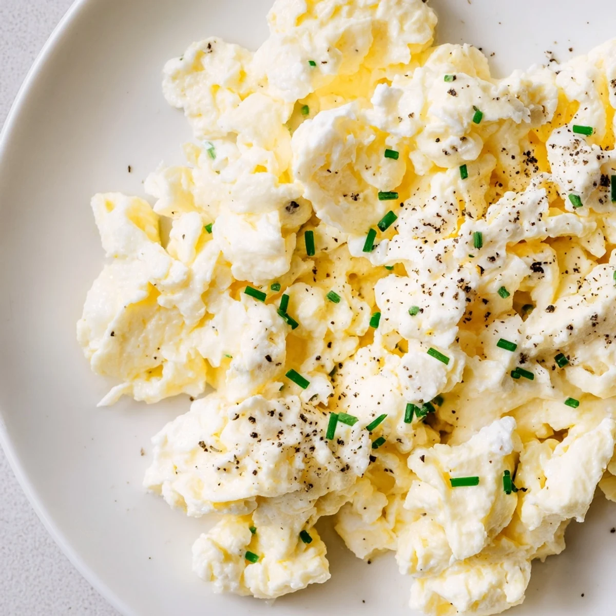 Golden Cottage Cheese Scrambled Eggs with pepper, ready to enjoy with whole-grain toast.