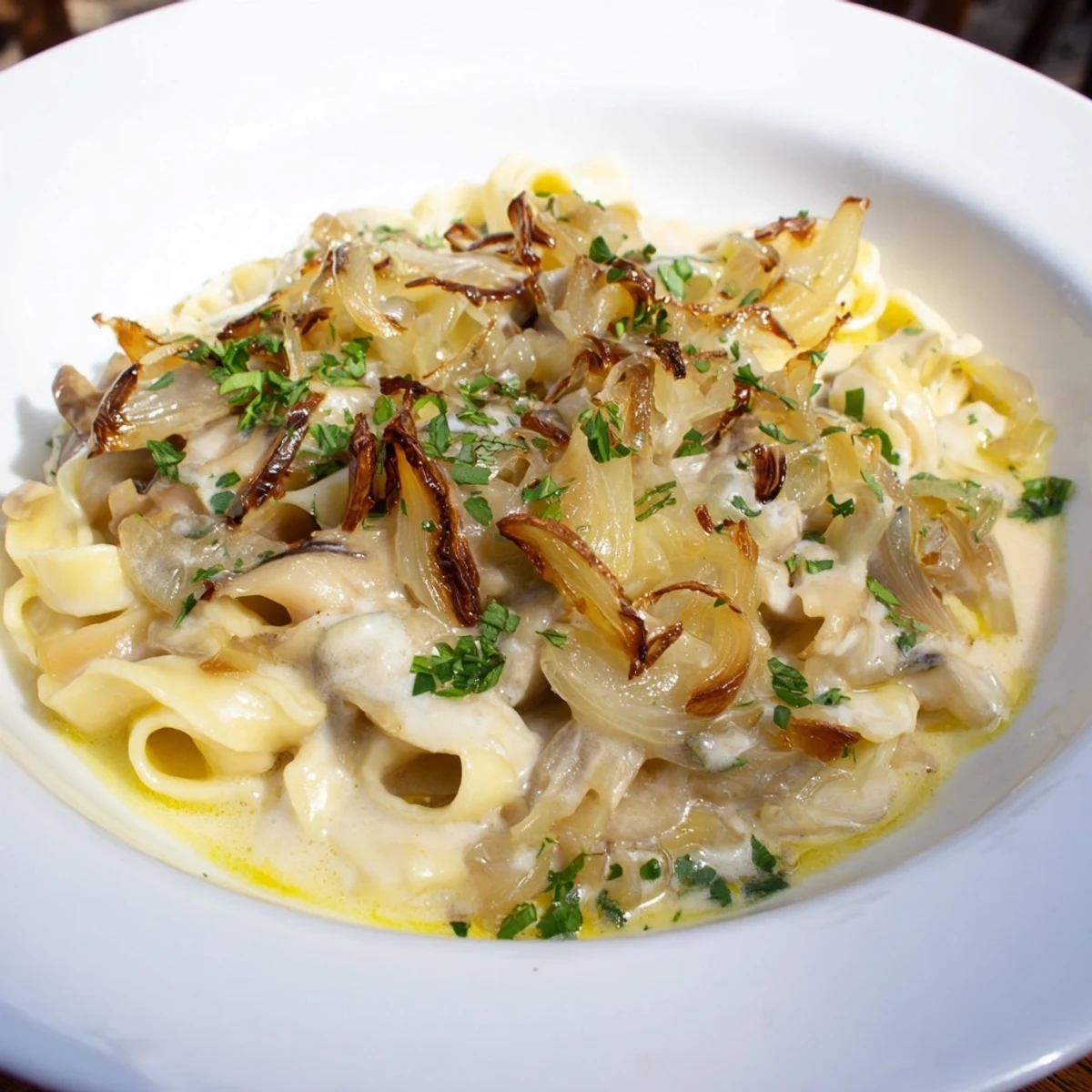 A close-up of cheesy One-Pot French Onion Pasta with caramelized onions, ready to eat and enjoy.