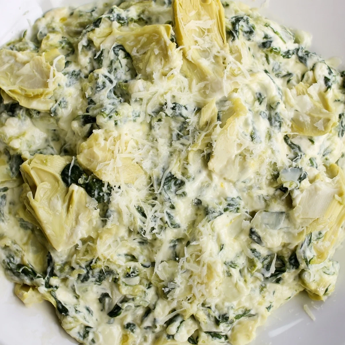 Golden, bubbly spinach artichoke dip, a warm appetizer served with crispy tortilla chips.