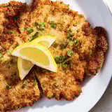 Crispy-coated Wiener Schnitzel, the classic Austrian main dish, revealing juicy veal beneath the golden crust.