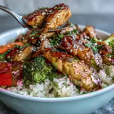 Honey Garlic Chicken Bowl served steaming hot with broccoli, carrots, and red bell peppers, ready for a quick family dinner.