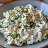 High-protein cottage cheese scrambled eggs served with fresh chives for a nourishing start.