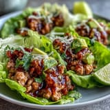Savory ground turkey taco filling spooned into crisp lettuce cups for a healthy meal.