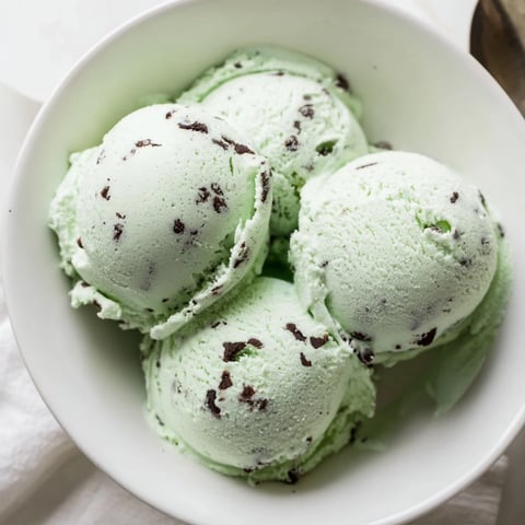 Creamy Mint Chocolate Chip Ice Cream swirled with dark chocolate chips, perfect dessert!