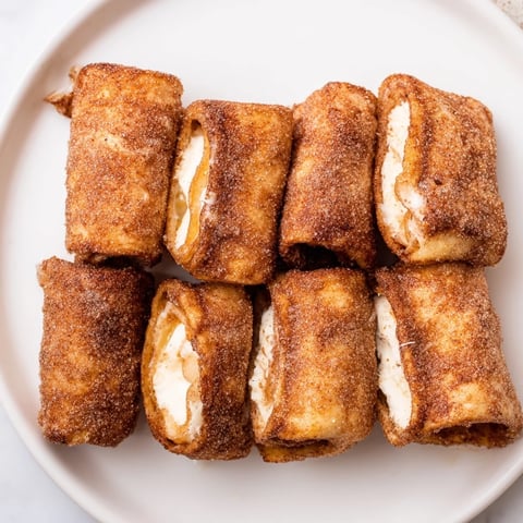 Golden, cinnamon-dusted Easy French Toast Roll-Ups, perfect for a quick breakfast treat or snack.