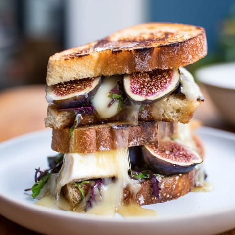 Perfectly grilled Fig, Brie & Arugula sandwich, showcasing creamy cheese and peppery arugula.