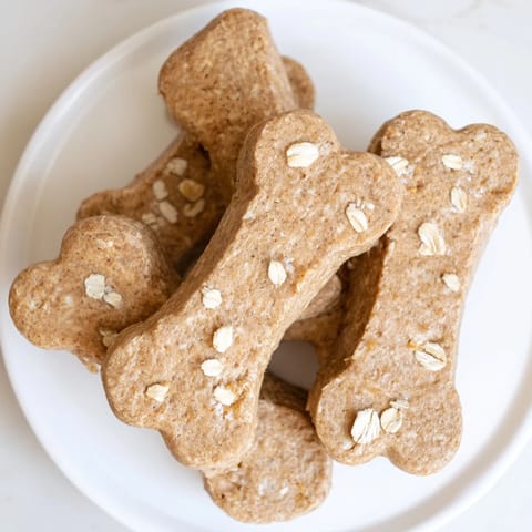 Freshly baked Pawsitively Good Dog Bone Treats, smelling of peanut butter and ready to cool.