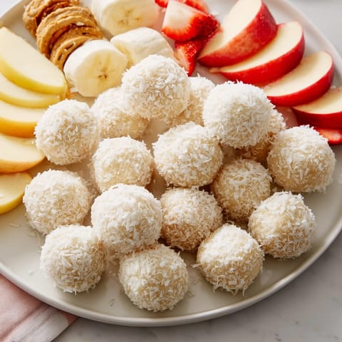 Sweet coconut-covered Marshmallow Snowball Dip, a delicious party treat with easy dippers.