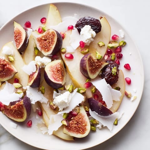 Artfully arranged fig and date snowdrift platter, garnished with pomegranate seeds and pistachios.