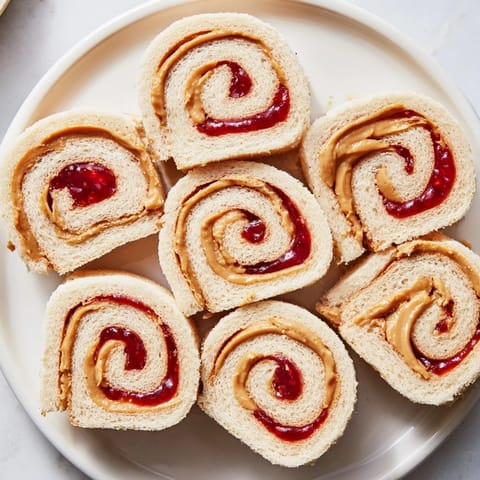 Quartered PB&J pinwheel rolls, a colorful, easy-to-make lunch perfect for kids and adults.