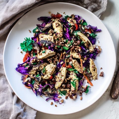 Fresh carrot ribbons and chicken are tossed in a flavorful dressing for this vibrant Chicken Slaw salad.