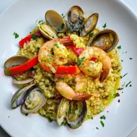 Sizzling shrimp and mussels top the flavorful, saffron-infused rice of this Spanish seafood paella.