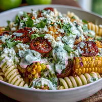 Mexican Street Corn Elote Pasta Salad with charred corn and cotija cheese in a tangy lime dressing.
