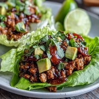 Juicy Turkey Taco Lettuce Wraps piled high with fresh avocado and vibrant cilantro.